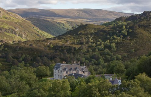 A stone estate resting in a green Highland valley