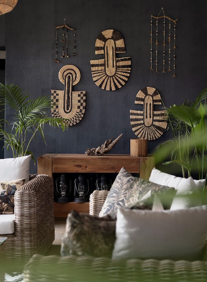 The lodge interior at Sashwa — woven wall hangings, plants and wicker