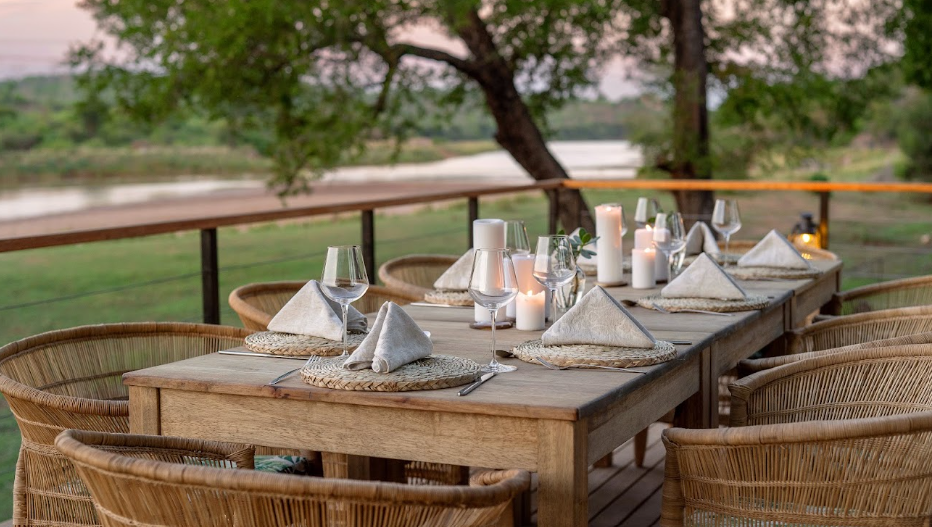 A candlelit dining table set above the river